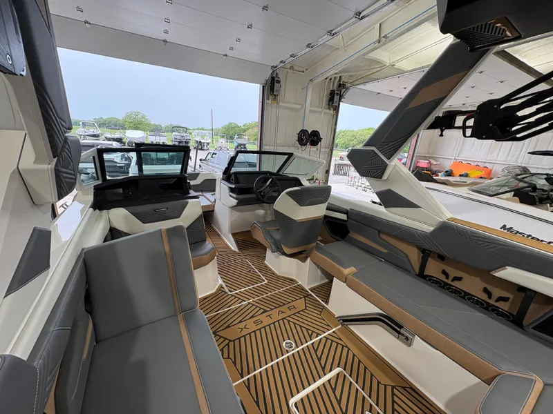 Slide: The Image of 2025 MasterCraft XStar 23 interior with sleek gray and tan seating, modern design. - 15