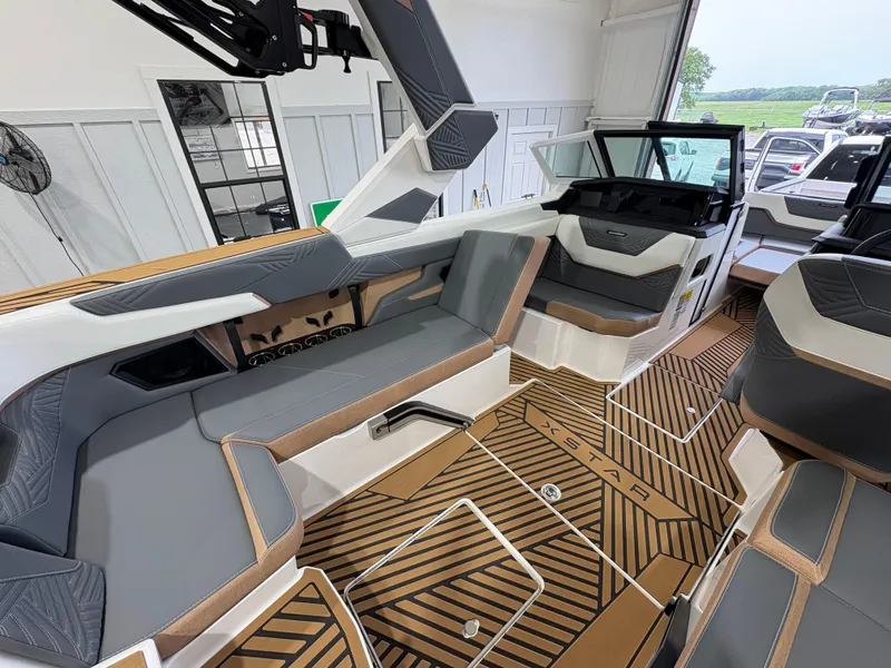 Slide: The Image of 2025 MasterCraft XStar 23 interior with sleek gray and tan seating, modern design. - 16