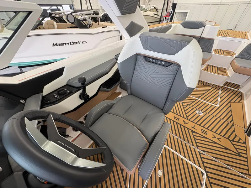 Slide: The Image of 2025 MasterCraft XStar 23 interior at Dallas Boathouse showroom, featuring modern design and technology. - 19