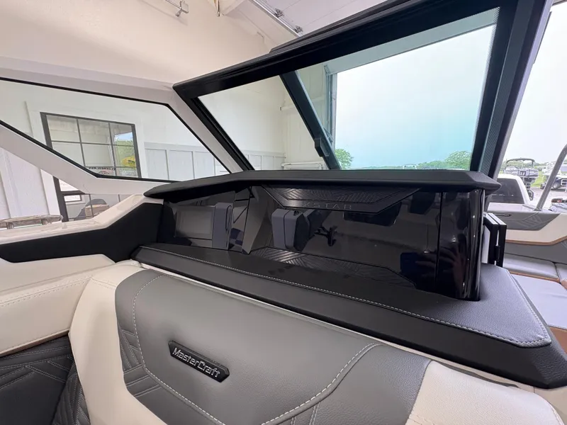 Slide: The Image of 2025 MasterCraft XStar 23 boat with supercharged 6.2L engine badge. - 22