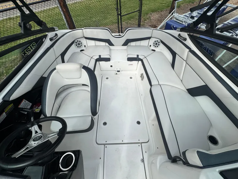 Slide: The Image of 2014 Yamaha Boats 212X interior with white seating and steering wheel. - 11