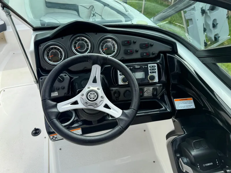 Slide: The Image of 2014 Yamaha Boats 212X dashboard with steering wheel and control panel. - 8