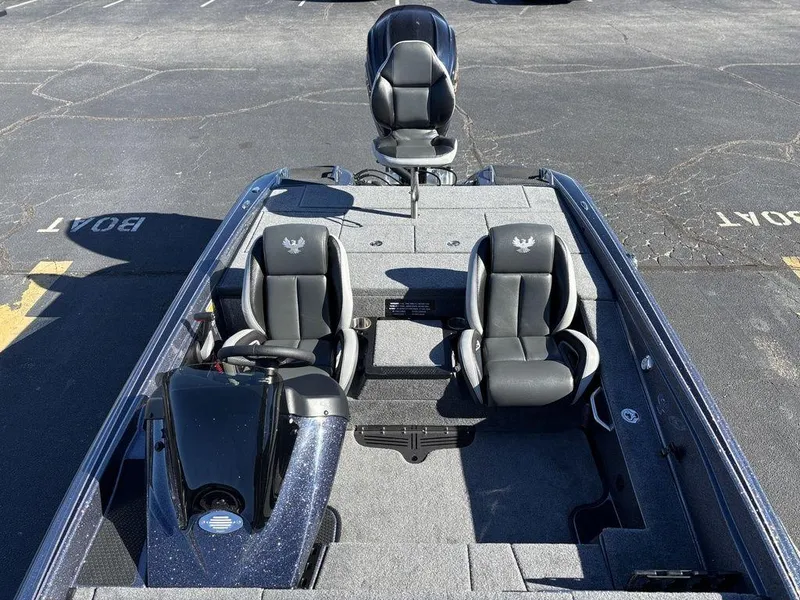 Slide: The Image of 2025 Phoenix 721 ZXL boat interior with three black seats, parked on asphalt. - 11