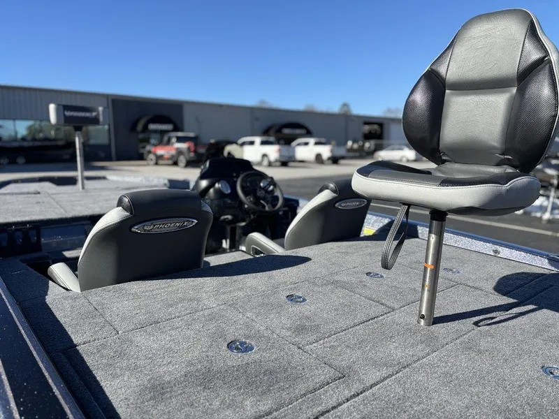 Slide: The Image of 2025 Phoenix 721 ZXL boat interior with seating and control console, parked outdoors. - 13
