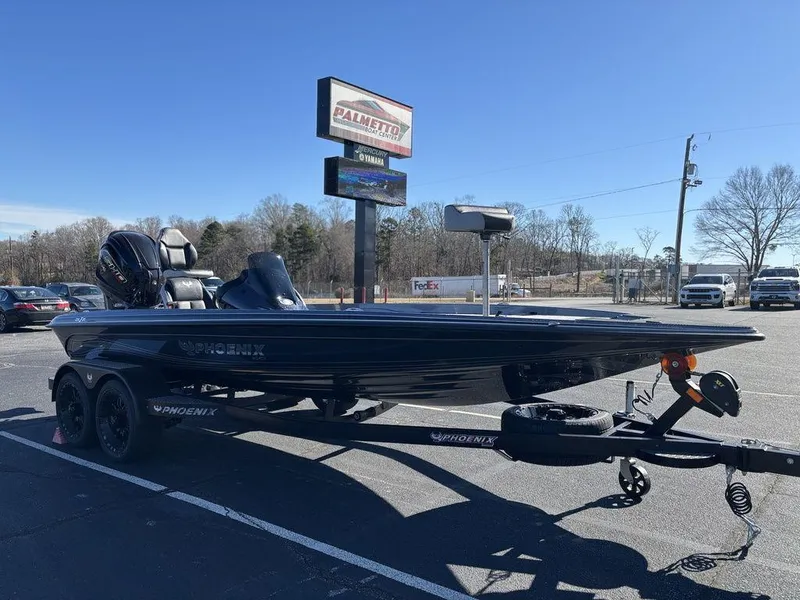 Slide: The Image of 2025 Phoenix 721 ZXL boat on trailer in parking lot, clear sky background. - 14