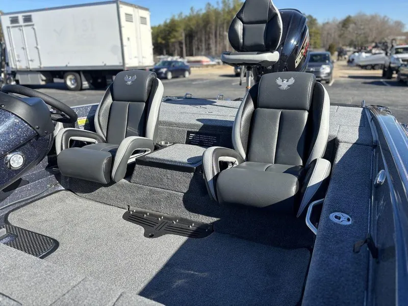 Slide: The Image of 2025 Phoenix 721 ZXL boat interior with two black and gray seats, outdoors. - 9