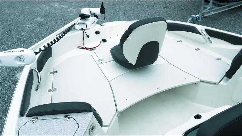 Slide: The Image of 2019 Stingray 206 CC boat interior with seating and control panel. - 10