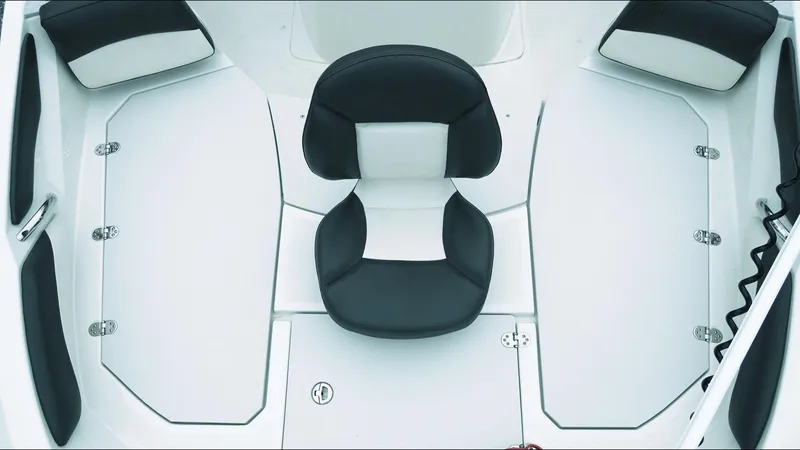 Slide: The Image of 2019 Stingray 206 CC boat interior with black and white seating and storage compartments. - 11