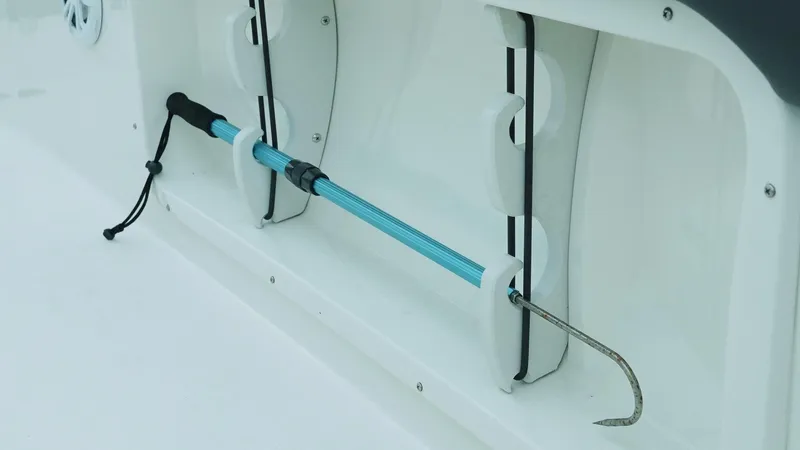 Slide: The Image of Storage compartment with a boat hook on a 2019 Stingray 206 CC. - 13