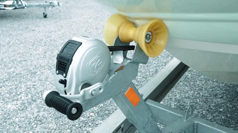 Slide: The Image of Trailer winch and roller for 2019 Stingray 206 CC boat on gravel surface. - 18