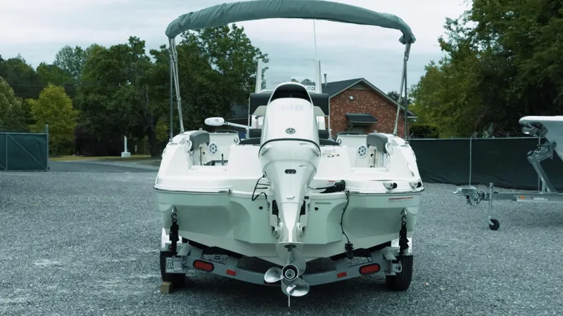 Slide: The Image of 2019 Stingray 206 CC boat on trailer, parked outdoors, rear view. - 3