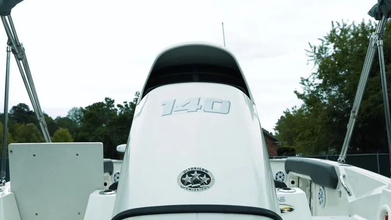 Slide: The Image of 2019 Stingray 206 CC boat with 140 horsepower engine, outdoor setting. - 5