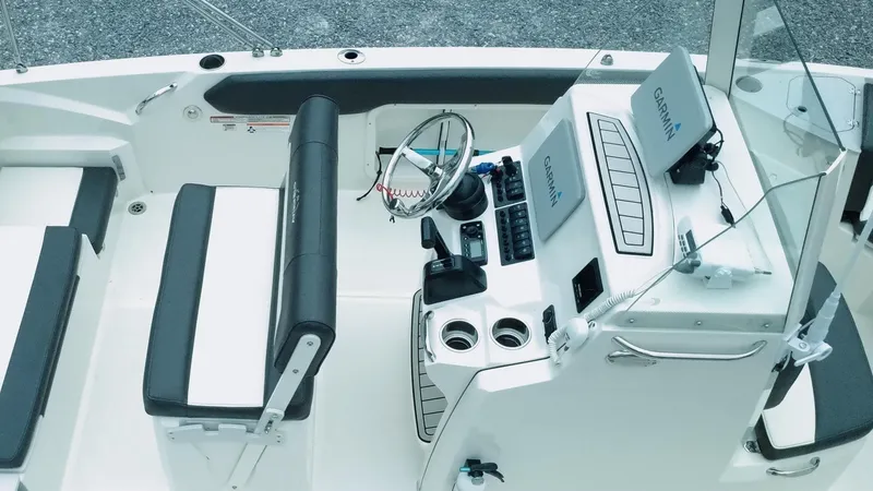 Slide: The Image of 2019 Stingray 206 CC boat interior with steering console and seating. - 6