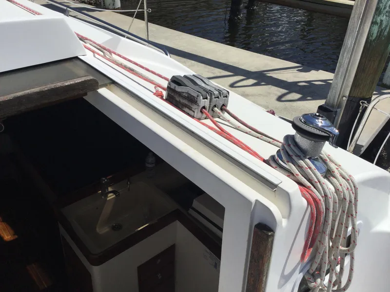 Slide: The Image of 1997 J Boats J/32 sailboat deck with winch and ropes near cabin entrance. - 15