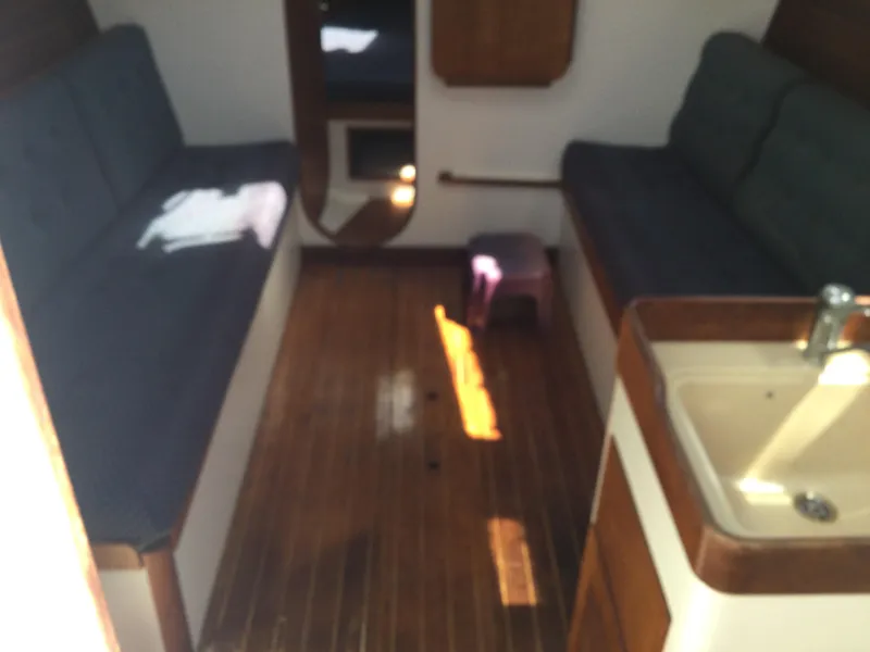 Slide: The Image of Interior of 1997 J Boats J/32 sailboat with wooden flooring and seating. - 25