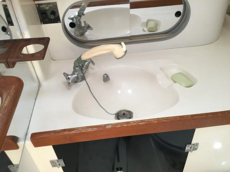 Slide: The Image of 1997 J Boats J/32 bathroom sink with mirror and wooden accents. - 29