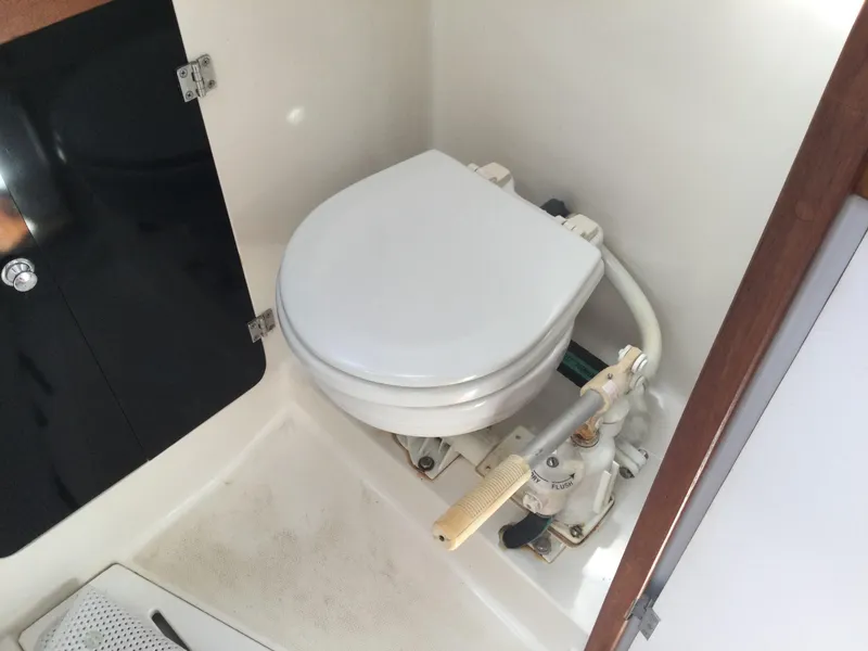 Slide: The Image of 1997 J Boats J/32 marine toilet with manual pump in compact bathroom. - 30
