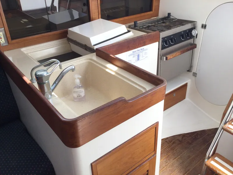 Slide: The Image of 1997 J Boats J/32 yacht interior with kitchen sink and stove. - 33