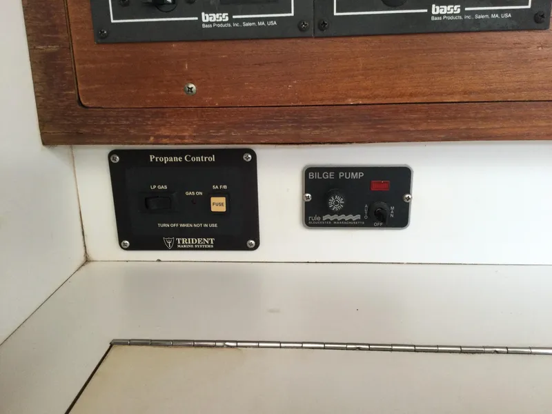 Slide: The Image of Control panel on a 1997 J Boats J/32, featuring propane and bilge pump controls. - 38