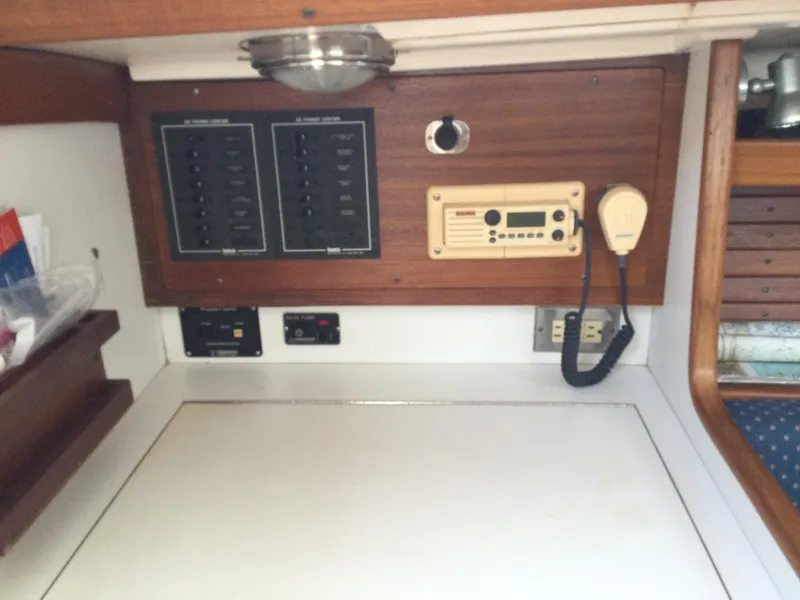 Slide: The Image of 1997 J Boats J/32 interior control panel with radio and electrical switches. - 39