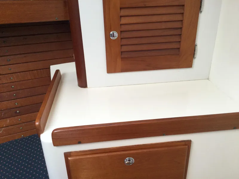 Slide: The Image of Interior of 1997 J Boats J/32, featuring wooden cabinetry and white surfaces. - 42