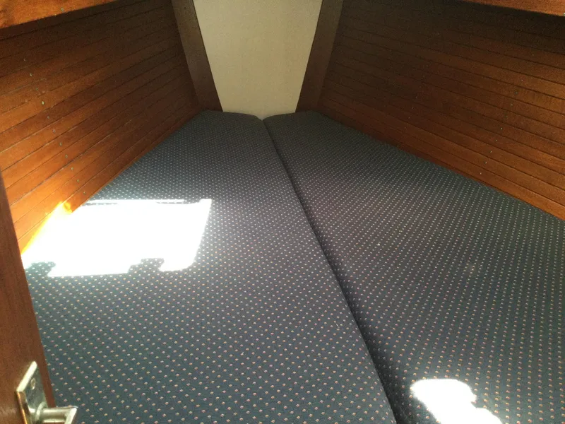 Slide: The Image of Interior cabin of 1997 J Boats J/32 with blue cushioned bedding. - 43