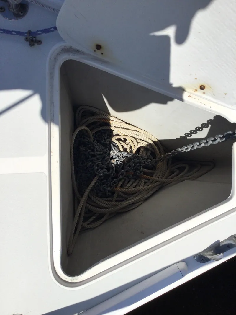 Slide: The Image of Anchor locker of a 1997 J Boats J/32 with rope and chain. - 49