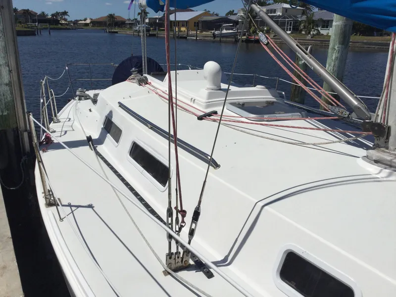 Slide: The Image of 1997 J Boats J/32 sailboat docked by the water, showcasing deck and rigging. - 6