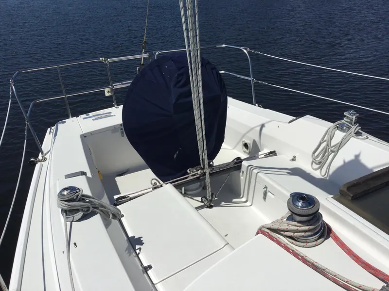 Slide: The Image of 1997 J Boats J/32 sailboat cockpit with ropes and winches on calm water. - 9