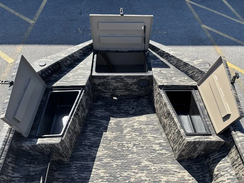 Slide: The Image of Open storage compartments on a 2025 Havoc RDBST 1553 boat, featuring a camouflage design. - 10
