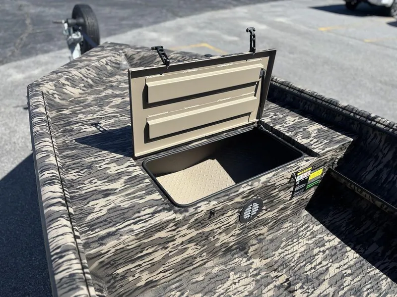 Slide: The Image of Open storage compartment on 2025 Havoc RDBST 1553 boat, featuring camouflage design. - 12