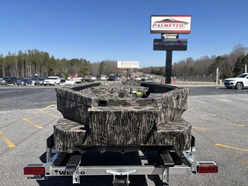 Slide: The Image of Camouflage-patterned 2025 Havoc RDBST 1553 boat on trailer in parking lot. - 3