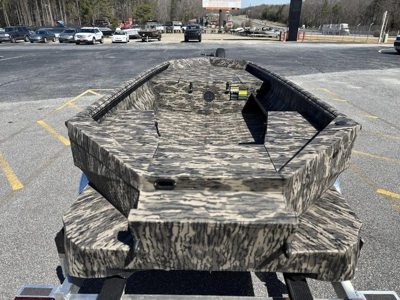 Slide: The Image of Camouflage-patterned 2025 Havoc RDBST 1553 boat on trailer in parking lot. - 4