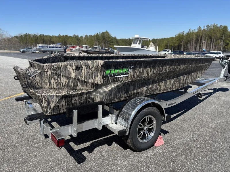 Slide: The Image of 2025 Havoc RDBST 1553 boat on trailer, camo design, parked outdoors. - 5