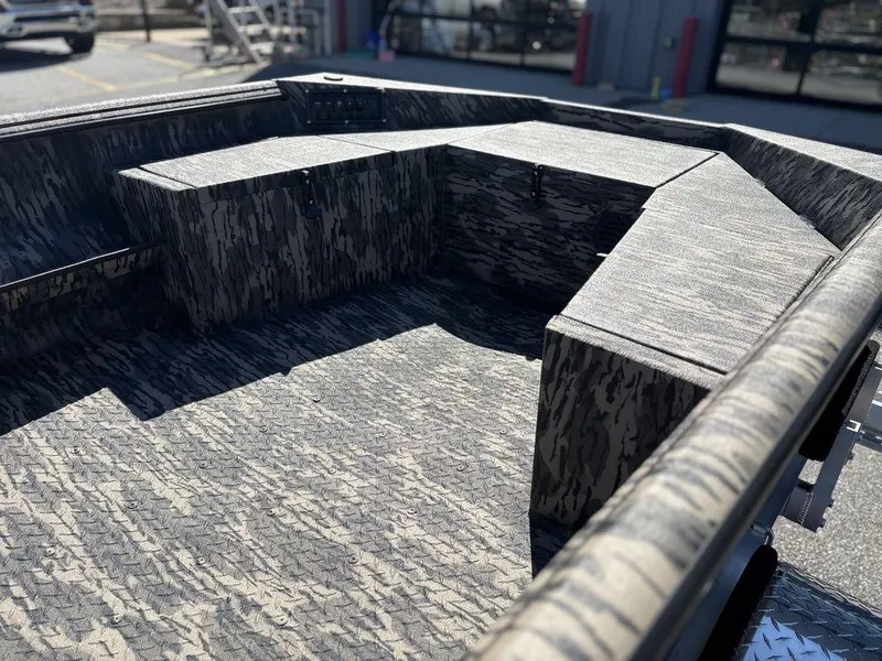 Slide: The Image of 2025 Havoc RDBST 1553 boat interior with camouflage design and seating area. - 8