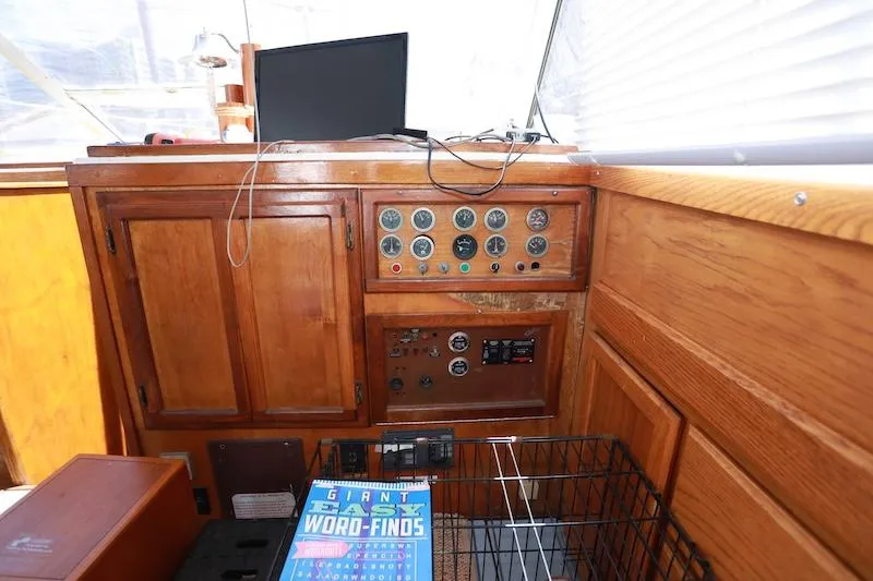 Slide: The Image of 1972 Trojan 36 boat interior with wooden dashboard and control panel. - 13