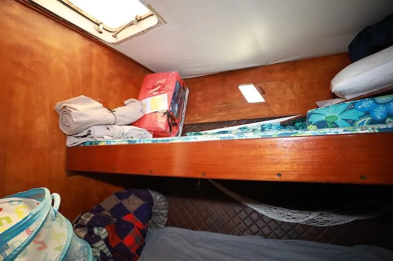 Slide: The Image of Cozy cabin interior of 1972 Trojan 36 boat with bunk beds and storage. - 18