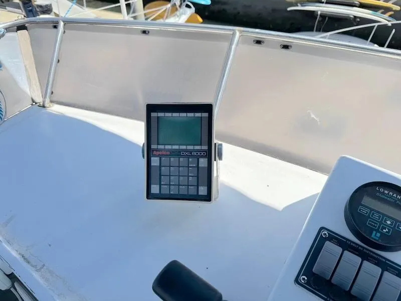 Slide: The Image of Control panel on a 1972 Trojan 36 boat, featuring a digital display and navigation equipment. - 25