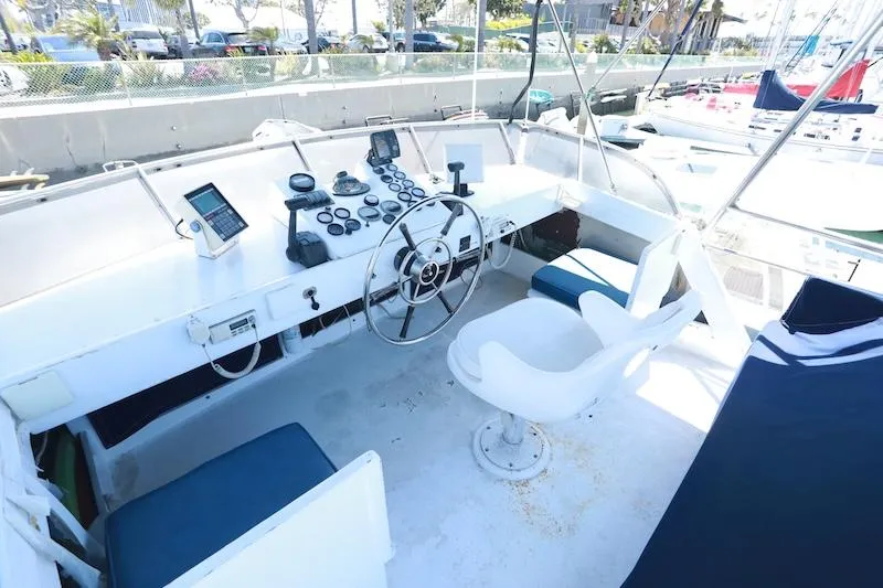 Slide: The Image of 1972 Trojan 36 boat cockpit with steering wheel and navigation instruments. - 5