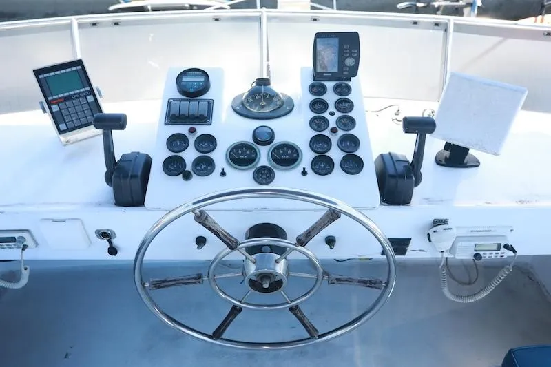 Slide: The Image of Control panel of a 1972 Trojan 36 boat with steering wheel and gauges. - 6