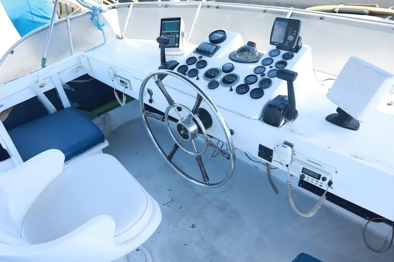 Slide: The Image of 1972 Trojan 36 boat cockpit with steering wheel and navigation instruments. - 7