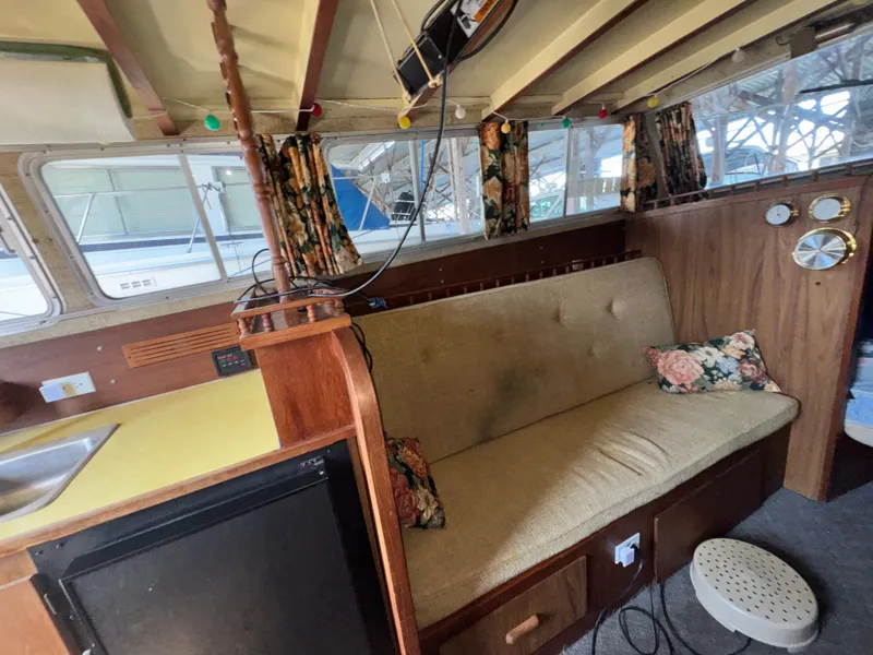 Slide: The Image of Interior of a 1974 Roberts 30' boat with vintage decor and cozy seating area. - 15