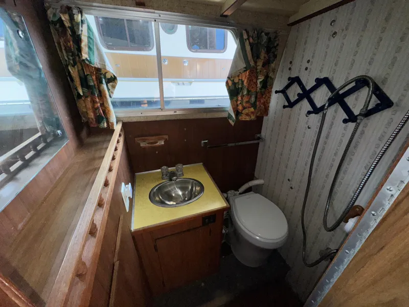 Slide: The Image of 1974 Roberts 30' boat bathroom with sink, toilet, and shower. - 25