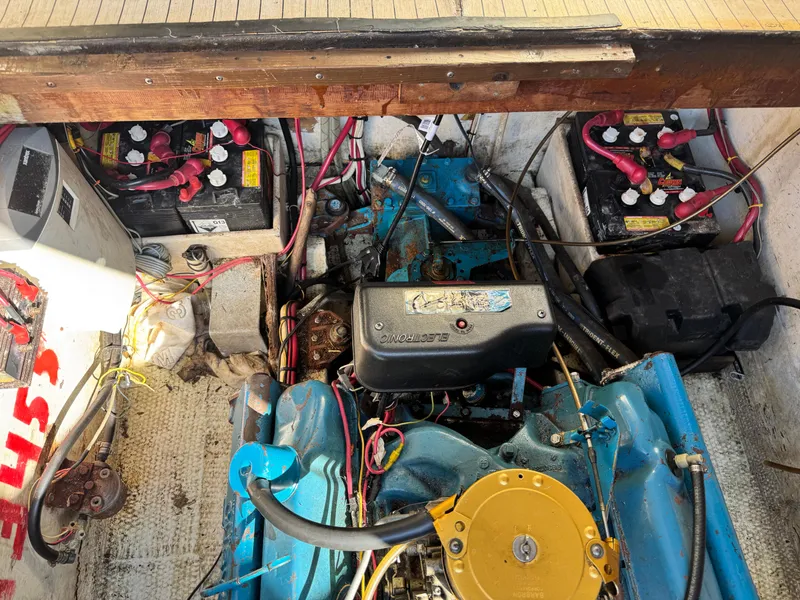 Slide: The Image of Engine compartment of a 1974 Roberts 30' boat with visible batteries and wiring. - 27