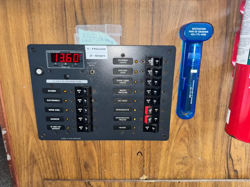 Slide: The Image of Electrical panel on a 1974 Roberts 30' boat, showing voltage and circuit switches. - 30