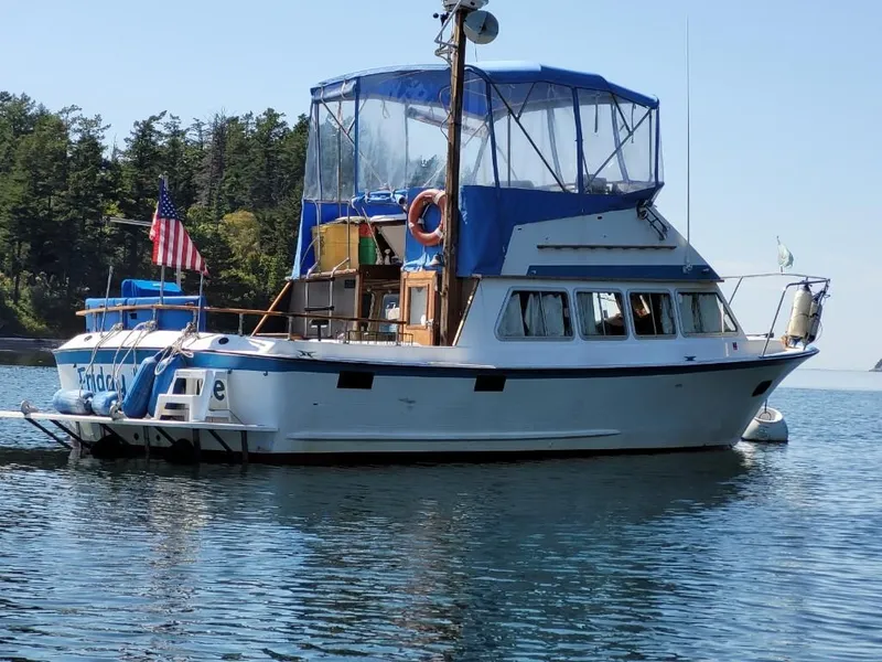 Slide: The Image of 1974 Roberts 32 boat on calm water with forested background. - 36