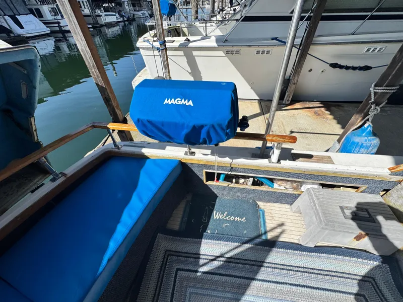 Slide: The Image of 1974 Roberts 30' boat deck with blue Magma grill cover and welcome mat. - 4