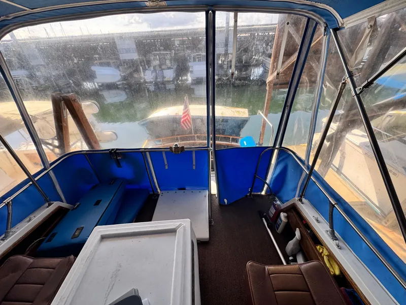 Slide: The Image of Interior view of a 1974 Roberts 30' boat with blue seating and clear windows. - 7