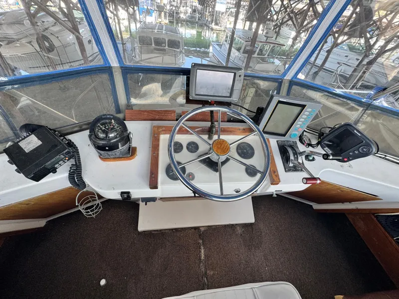 Slide: The Image of Helm of a 1974 Roberts 30' boat with navigation equipment and steering wheel. - 8