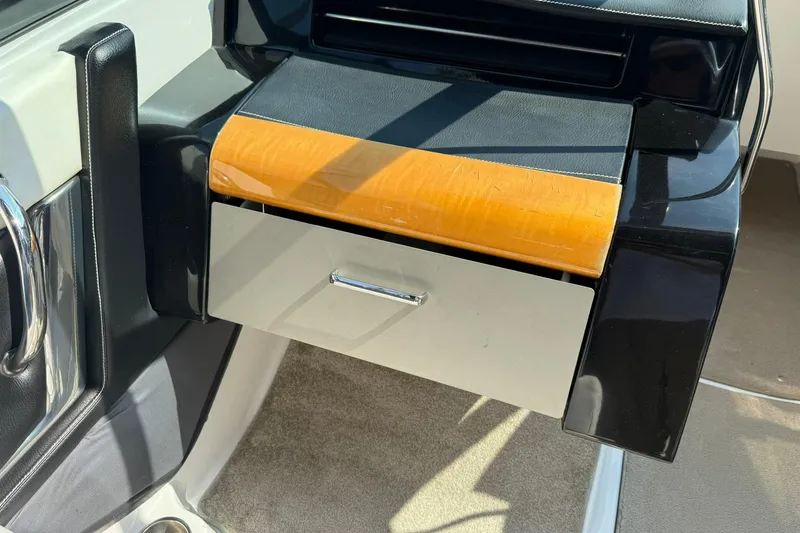 Slide: The Image of 2009 Four Winns SL222 boat dashboard with open glove compartment. - 10